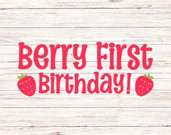 May include: A red graphic with the words "Berry First Birthday!" in a playful font, with strawberry illustrations on either side. The text and strawberries are set against a white wooden background.