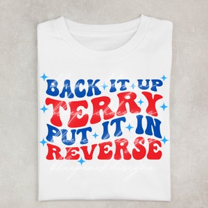 May include: White t-shirt with a red and blue graphic that says "Back it up Terry Put it in Reverse".