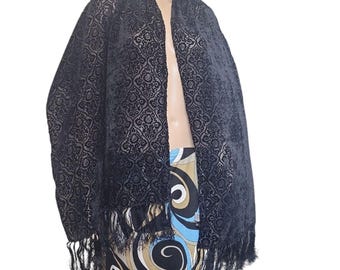 May include: Black velvet shawl with a geometric pattern and fringe trim.