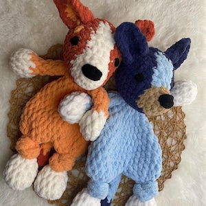 May include: Two crocheted stuffed dog toys. One is orange and white, the other is blue and white.