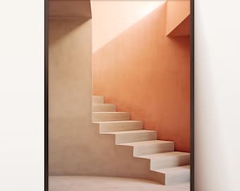 Puede incluir: Impresión artística enmarcada que presenta un diseño arquitectónico minimalista. La imagen muestra una escalera ascendiendo contra una pared color melocotón, con una pared beige contrastante a la izquierda. La composición se baña en luz natural, creando sombras.