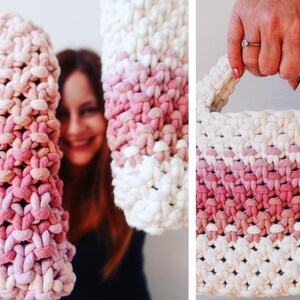 May include: Handmade crochet bag in shades of pink and white. The bag features a textured, woven design with a gradient effect. The handles are also crocheted, and the bag appears sturdy and well-crafted. A stylish and unique accessory.
