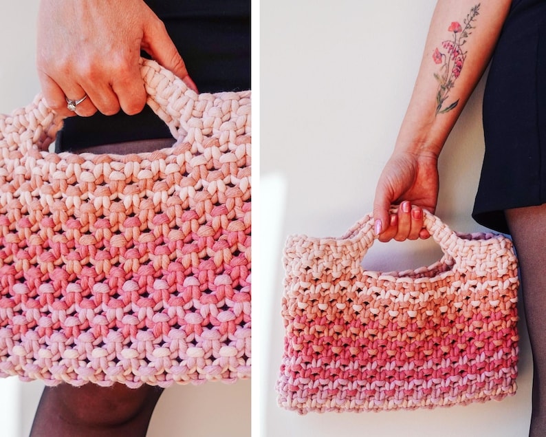May include: A hand-held, woven tote bag with a gradient color scheme, transitioning from light beige to a vibrant pink. The bag features a rectangular shape with sturdy handles, showcasing a textured, knotted design.
