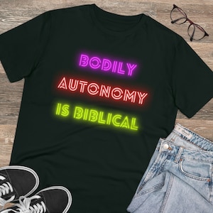 May include: Black t-shirt with the text "BODILY AUTONOMY IS BIBLICAL" in neon pink, red, and green.