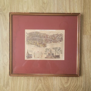 May include: A framed antique map of London, England, with a red mat and gold frame. The map shows the area around "Newgate Wall" and "Part of London Wall".