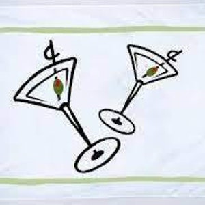 May include: White rectangular kitchen towel with a light green border and four green olives in the corners. Two martini glasses with olives are in the center, drawn in black.