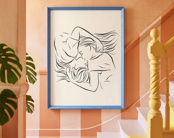 May include: A rectangular wall art print featuring a black line drawing of two figures embracing on a cream background, enclosed within a bright blue wooden frame. The artwork depicts the silhouettes of two people in a close, intimate pose.