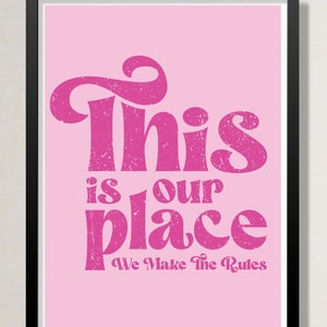 May include: Pink framed print with the text "This is our place We Make The Rules" in a pink distressed font.