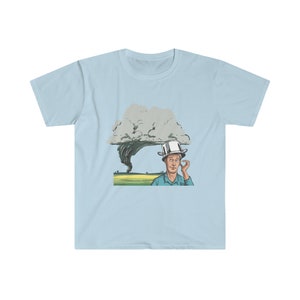 May include: A light blue t-shirt with a cartoon illustration of a person wearing a pot on their head, standing in a field with a tornado in the background.