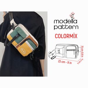 Pode incluir: Uma pochete multicolorida com vários bolsos e uma alça preta. A bolsa mede 23 cm de largura, 15 cm de altura e 5 cm de profundidade.