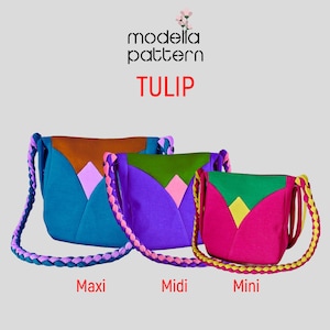 May include: Three colourful fabric handbags in different sizes, labelled "Maxi", "Midi", and "Mini". The bags are all made of a soft, quilted fabric and have a braided strap. The bags are all different colours, with the largest bag being teal, the middle bag being purple, and the smallest bag being pink.