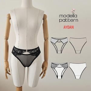 Può includere: Lingerie nera con finiture in pizzo e design a chiave di volta esposta su un manichino. L'immagine include anche un diagramma del modello con il testo "modella pattern AYDAN".
