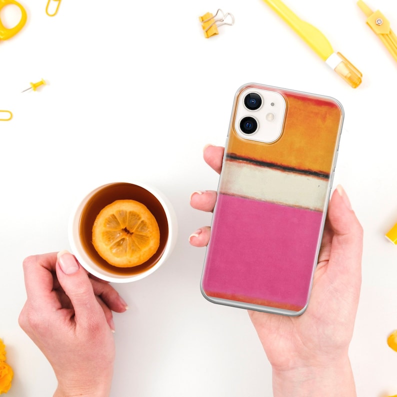 May include: A pink, white, orange, and brown abstract design phone case for an iPhone.
