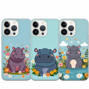 May include: Three iPhone cases with a light blue background and a cartoon hippopotamus design. The hippos are in different poses and have different colored eyes. The cases have a white camera bump and a white border around the edges.