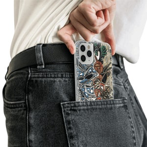 May include: A person wearing jeans with a black belt and a clear phone case with a colorful abstract design in their back pocket.