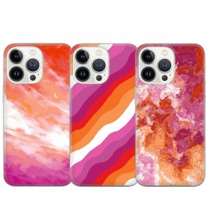 以下が含まれることがあります： 異なるデザインのiPhoneケースが3つあります。最初のケースは、ピンクとオレンジの水彩画の空のデザインです。2番目のケースは、ピンク、オレンジ、白のストライプのデザインです。3番目のケースは、ピンクとオレンジの大理石のデザインです。