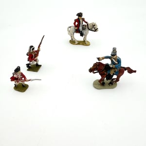 May include: Miniature toy soldiers depicting historical figures in red, blue, and white uniforms. One soldier is mounted on a white horse, another on a brown horse. Two soldiers are standing with rifles, and one is pointing a pistol.