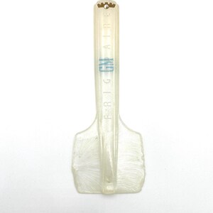 May include: A clear plastic ice scraper with a blue "FRIGIDAIRE" logo printed on the handle.