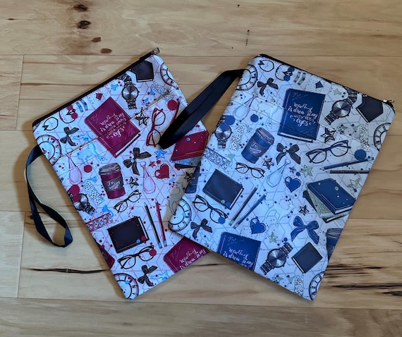 Pink or blue book-themed zipper sleeve with front pocket.
