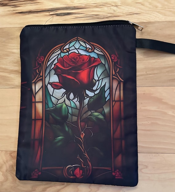 Rose-patterned book cover with zipper and front pocket.