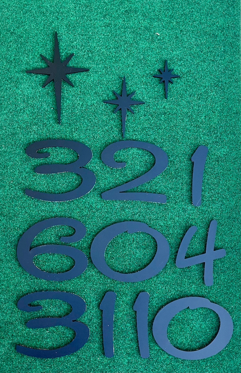 May include: Black metal numbers and stars on a green background. The numbers are 3, 2, 1, 6, 0, 4, 3, 1, 1, and 0.