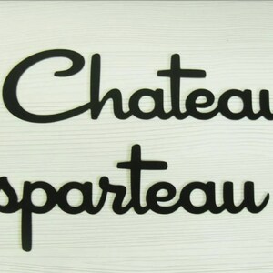 May include: Black wooden sign with the text "Chateau Esparteau" in a retro font. The sign is decorated with stylized starbursts.