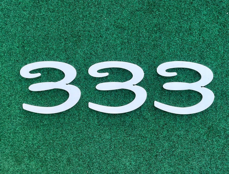 May include: White number 333 on a green background.
