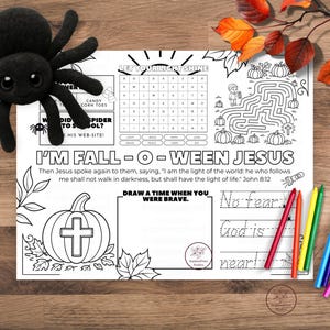 Printable Fall-o-Ween Jesus themed coloring placemat featuring pumpkins, fall leaves, crosses, and Bible verse elements with "Jesus is the Light" and Bo Fear, God is Near message, designed as a kids Christian Halloween alternative activity worksheet.
