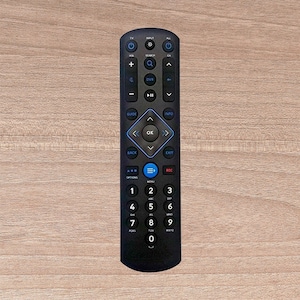 May include: Black remote control with a variety of buttons, including channel up and down, volume up and down, guide, info, back, exit, menu, and number buttons.
