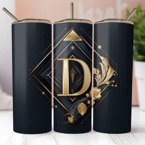 May include: Three black and gold stainless steel tumblers with a geometric design and the letter "D" in the center. The tumblers have a gold straw and lid.
