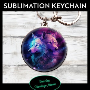 May include: A silver keychain with a round, colorful image of two wolves with a galaxy background. The text "Dancing Flamingo Mama" is on the bottom of the image.