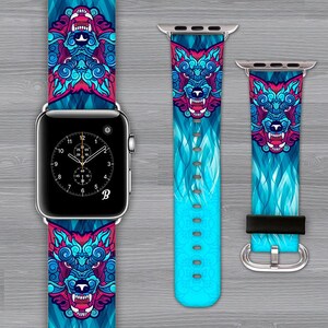 May include: A blue and pink Apple Watch band with a wolf design. The band has a blue and white flame pattern with a wolf's head in the center. The band is made of silicone and is compatible with Apple Watch Series 4 and later.