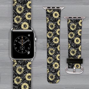 May include: A black and white watch band with a sunflower pattern. The band is compatible with Apple Watch.