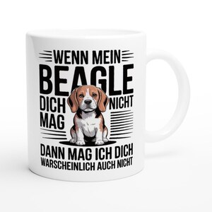 Könnte beinhalten: Weiße Keramik-Tasse mit einer Beagle-Illustration und dem deutschen Text "Wenn mein Beagle dich nicht mag, dann mag ich dich wahrscheinlich auch nicht." Die Tasse hat einen gebogenen Henkel und ist für heiße oder kalte Getränke geeignet.