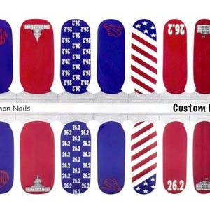 May include: Nail art strips with a patriotic theme. Designs include red, white, and blue patterns, the number 26.2, and Washington D.C. landmarks. The text "Marathon Nails" and "Custom Design" are also visible.