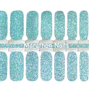 May include: A white ceramic mug with a black handle and the text "But First, Coffee" in a handwritten style. The mug is on a white surface. The mug is approximately 4 inches tall.