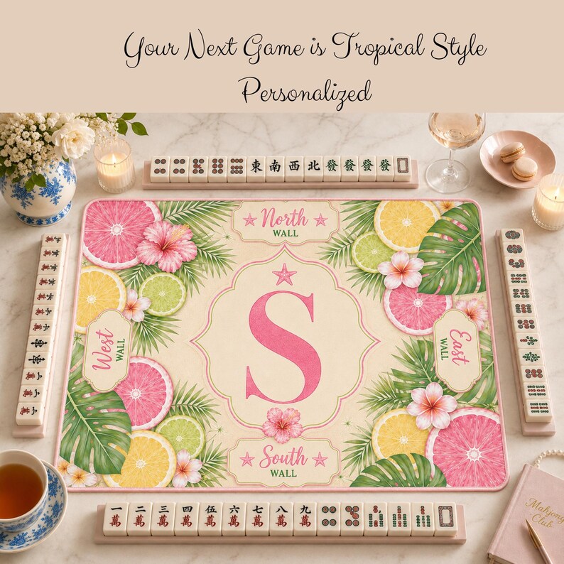 Personalized tropical mahjong mat with pink monogram S, citrus fruit accents, palm leaves, and premium quality product detail layout.