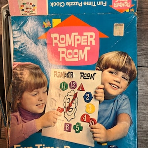 May include: A vintage Romper Room Fun Time Puzzle Clock box. The box is blue with the Romper Room logo and images of children. The puzzle clock features movable hands and puzzle numbers. Ages 2 1/2-6.