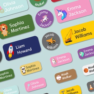 May include: A collection of colorful personalized name labels with various illustrations, including a lion, a panda, a unicorn, a rocket, a dump truck, a construction crane, a baseball, a basketball, a wand, and a traffic cone. The labels are perfect for personalizing school supplies, lunchboxes, and other belongings.