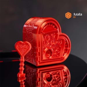 May include: A red heart-shaped box with intricate details and a matching key. The box is made of 3D printed plastic and has a hinged lid. The key is also 3D printed and has a heart-shaped head.