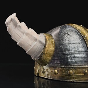 a close up of a helmet on a black surface