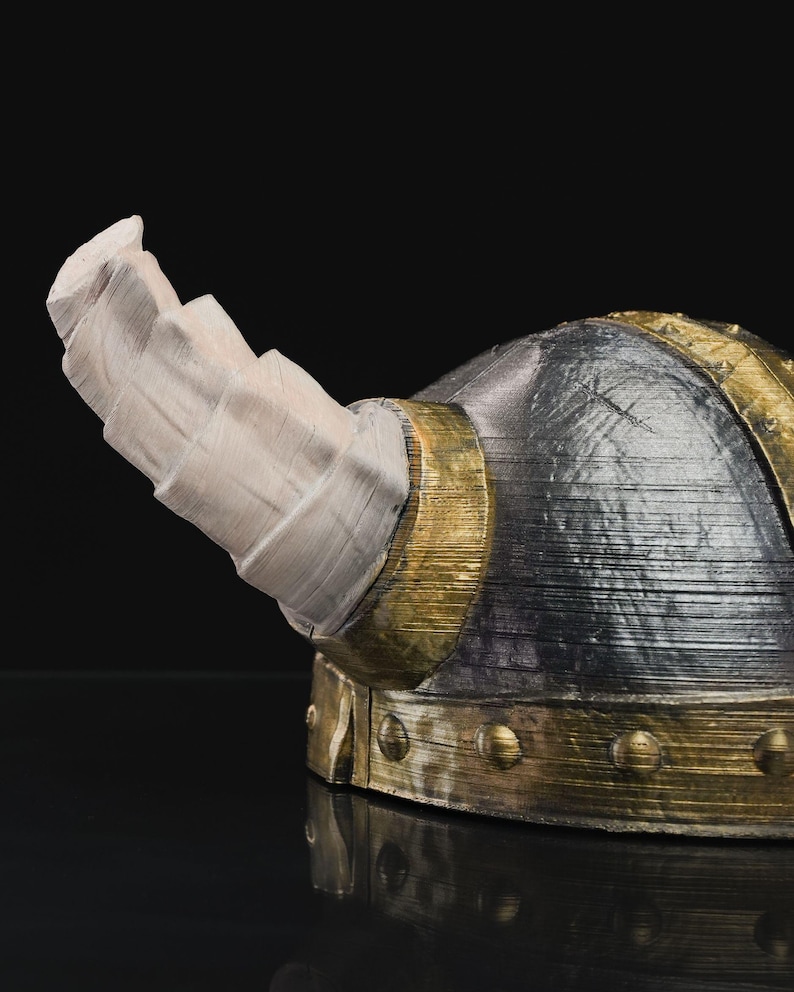 a close up of a helmet on a black surface