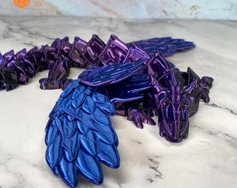 May include: A 3D printed dragon figurine with iridescent purple and blue scales. The dragon has wings and is posed in a crawling position. The figurine is made by Azata 3D.