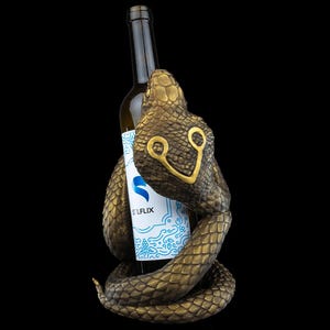 a monkey holding a bottle of beer in its mouth