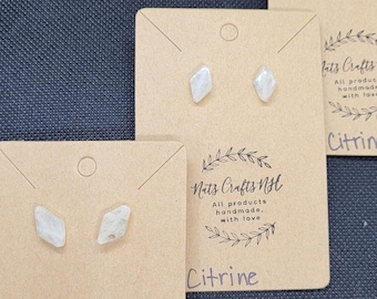 May include: Three pairs of citrine earrings on brown cards with the text "Nat's Crafts NH" and "All products handmade, with love" on each card.