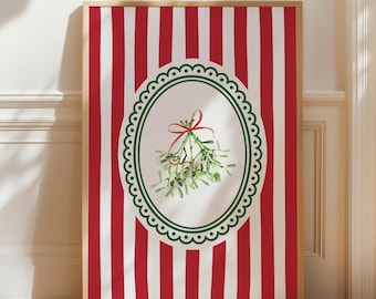 May include: A rectangular framed wall art print featuring a vertical red and white striped background. In the center, an oval frame with a scalloped green border encloses a watercolor illustration of green mistletoe tied with a red ribbon.