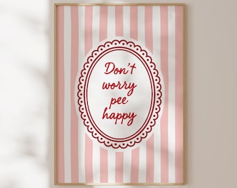 May include: A rectangular wall art print featuring a vertical pink and white striped background. In the center, a white oval with a decorative scalloped border contains the dark red text "Don't worry pee happy" written in a cursive script font.