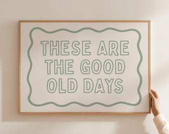 May include: A framed print with a white background and a green wavy border. The text inside the border reads "These are the good old days."