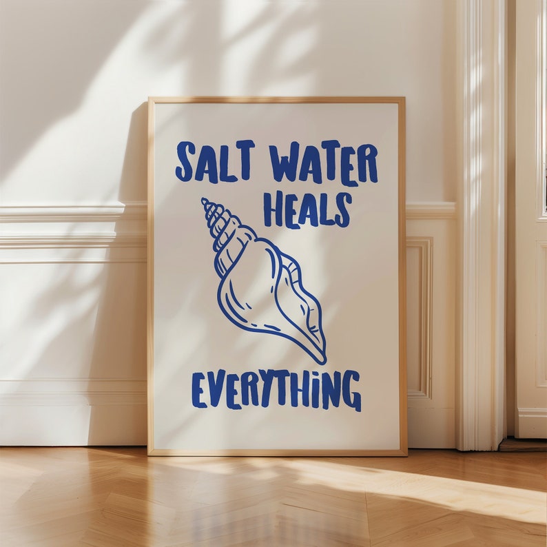 May include: A white framed poster with blue text that reads "Salt Water Heals Everything". A blue seashell illustration is centered on the poster.