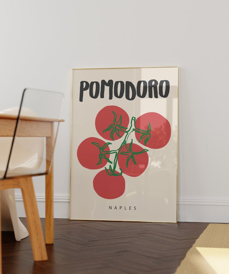 May include: A framed poster with a minimalist design featuring a red tomato vine with the word "POMODORO" in black text and the word "NAPLES" in black text at the bottom.